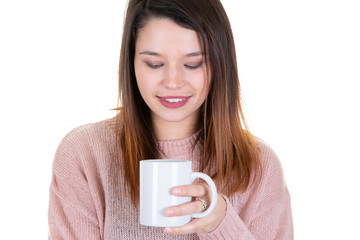 young woman with cup of coffee looks down pensive