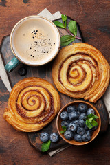 Obraz na płótnie Canvas Coffee and cinnamon rolls