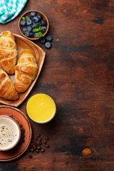 Coffee, juice and croissants breakfast