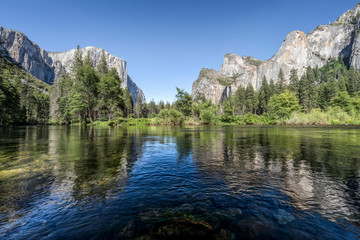 Yosemite Valley View - Iconic features of the sublime Yosemite Valley are viewed from the bank of California’s Merced River.