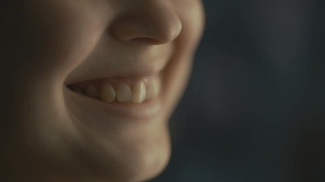 lips young woman talks at home with a friend at the window, part of the face is a girl smiling, concept of health and friendship