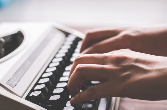 finger hold on button in vintage typewriter