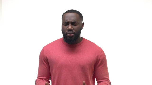 Slowmo upset shocked african american man nervously hearing bad news, looking confused realising situation getting sad, devastated, covering face hands, making pray gesture looking up disappointed