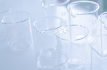 A pipette dropping sample into a test tube,abstract science background