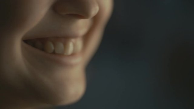 lips young woman talks at home with a friend at the window, part of the face is a girl smiling, concept of health and friendship
