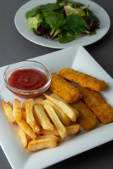 Closeup fish and chips with french fries - unhealthy food, grey backgrpound.