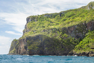 Naklejka na ściany i meble Tropical beach between the rocks. Paradise secluded island. 