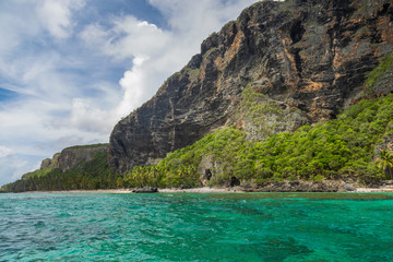 Fototapeta na wymiar Tropical beach between the rocks. Paradise secluded island. 