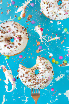 Floating in the air donuts on a blue background. Sweets, pastries.
