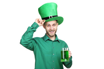 St. Patrick's Day. Young man wearing green hat with glass of beer on white background