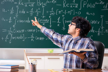 Funny male math teacher in the classroom 