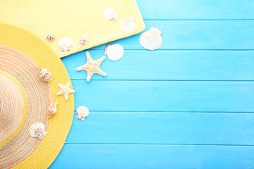 Summer accessories with seashells on blue wooden table