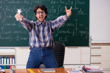 Funny male math teacher in the classroom 