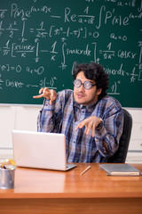 Funny male math teacher in the classroom 