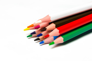 Colourful sharp pencils lie on a white background