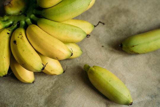 fresh mini bananas on the grey background