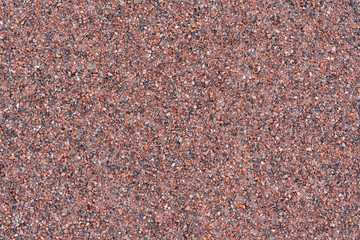 the texture of the stone wall of granite chips