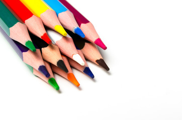 Colourful sharp pencils lie on a white background