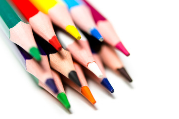 Colourful sharp pencils lie on a white background