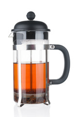 French press with fresh tea close up on white background