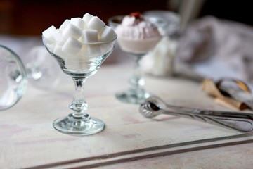White Refined Sugar Cubes in the sugar-bowl angle view on wooden background