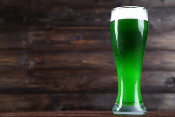 St. Patrick's Day. Glass of green beer on wooden background