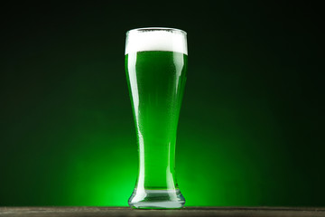 St. Patrick's Day. Glass of green beer on dark background