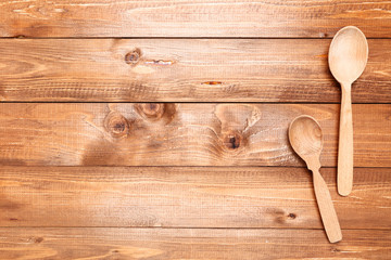 Wooden kitchen spoons on brown table