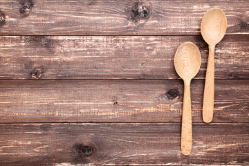Wooden kitchen spoons on brown table