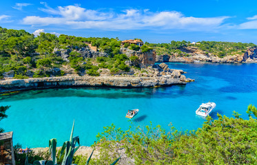 Summer vacation scene with sailboats on turquoise clean water on Mallorca Island near Cala Llombards beach - obrazy, fototapety, plakaty