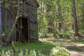 Fototapeta na wymiar Part of a barn next to a dirt trail