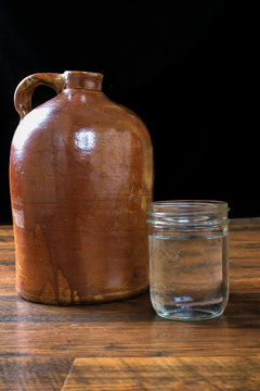 Moonshine in Crock Jug and Pint Fruit Jar on Dark BG