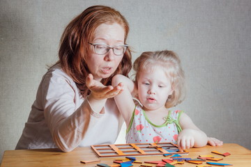 Naklejka premium mom and daughter collect puzzles