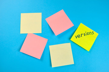  Many colored empty office stickers on a blue background and one separately. Mock-up