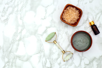 Beauty Products Facial Roller  on on a marble background. Copy space