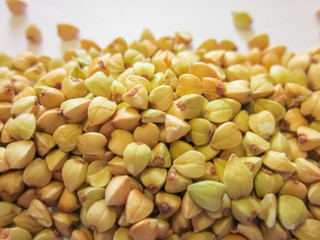 Pile of raw green buckwheat background. Vegan or vegetarian food