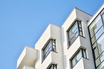 Modern white building with balcony on a blue sky