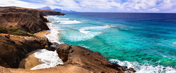 Wild beauty and unspoiled beaches of Fuerteventura. La Pared -popular surfer's spot, Canary islands - obrazy, fototapety, plakaty