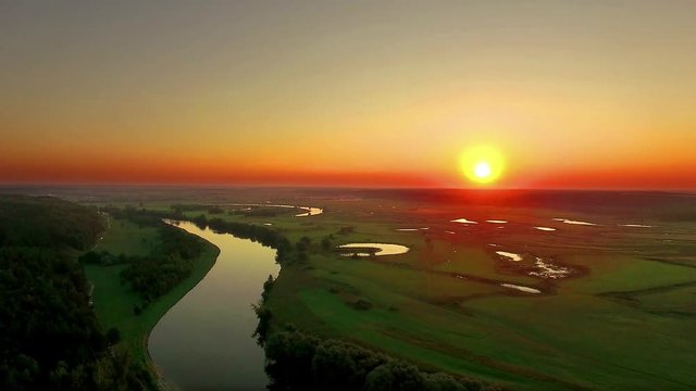 aerial view of river at sunrise 4K, fly over morning mist on the river, Very high view of the river at sunrise, Aerial view of mystical river at sunrise with fog, sun above the river aerial