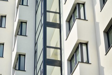 Modern white building with balcony on a blue sky
