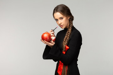 Attractive young girl with long braid and red bow