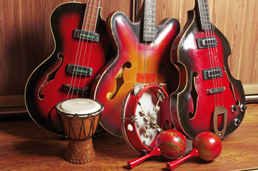 Fototapeta na wymiar Three electric guitars, tambourine, maracas, tambourine