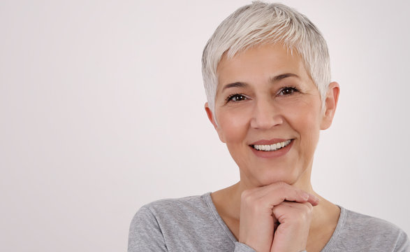 Happy Smiling Senior Woman Portrait on white background. Older skin care, beauty concept.