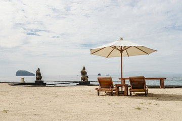 Beach lounge chairs with umbrella on the beach