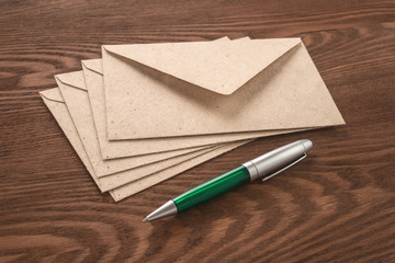 Envelopes and pen on a dark background