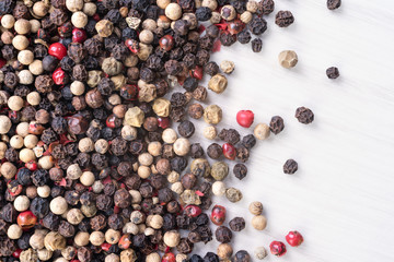 Different kind of pepper on wooden background