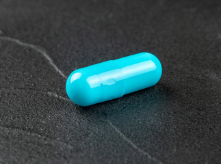 One blue capsule
