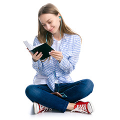 Young woman sitting reading book headphones smartphone on white background isolation