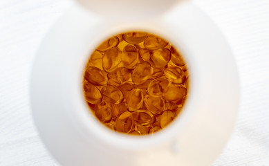 Capsules in container, on a white background