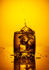 Ice cubes dropped into water with splash